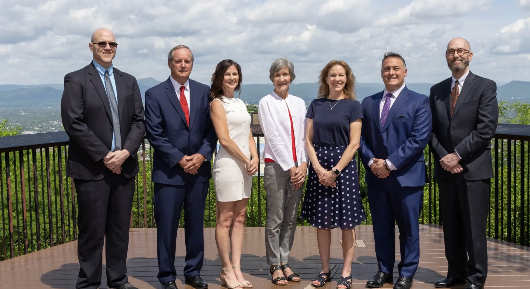 Picture of senior staff of DF Consultants standing together in a park.